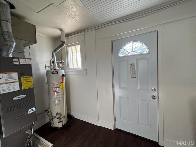 1014 E Broadway, Centralia, IL 62801 - foyer with water heater, dark wood-type flooring, and baseboards