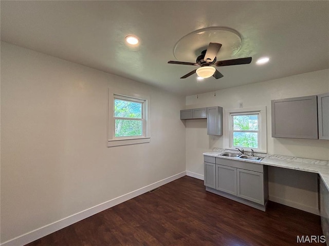 1014 E Broadway, Centralia, IL 62801 - kitchen with gray cabinets, a sink, baseboards, plenty of natural light, and recessed lighting