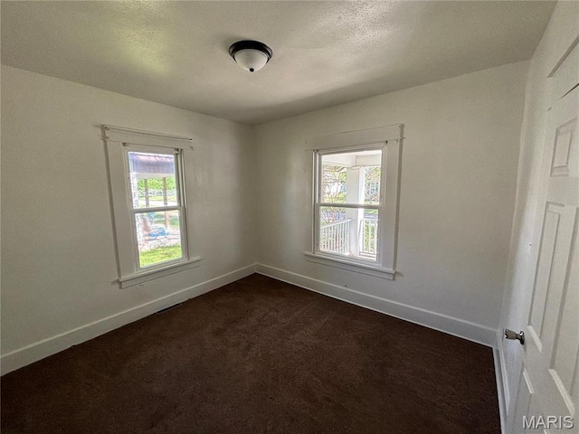1014 E Broadway, Centralia, IL 62801 - unfurnished room featuring baseboards and dark colored carpet