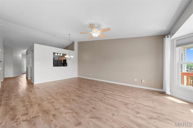 1149 Silo Bnd Unit 341A, Wentzville, MO 63385 - unfurnished living room with a ceiling fan, light wood-type flooring, lofted ceiling, a chandelier, and a textured ceiling