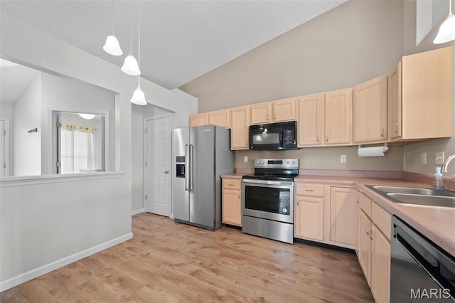 1149 Silo Bnd Unit 341A, Wentzville, MO 63385 - kitchen featuring stainless steel appliances, light brown cabinets, light countertops, light wood-style flooring, and high vaulted ceiling