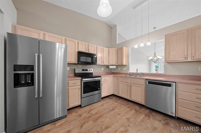 1149 Silo Bnd Unit 341A, Wentzville, MO 63385 - kitchen with stainless steel appliances, light brown cabinetry, a chandelier, light countertops, and a textured ceiling