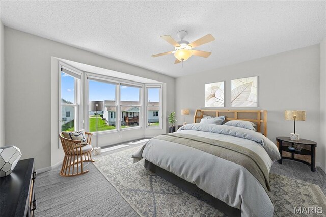1149 Silo Bnd Unit 341A, Wentzville, MO 63385 - carpeted bedroom with a textured ceiling and a ceiling fan