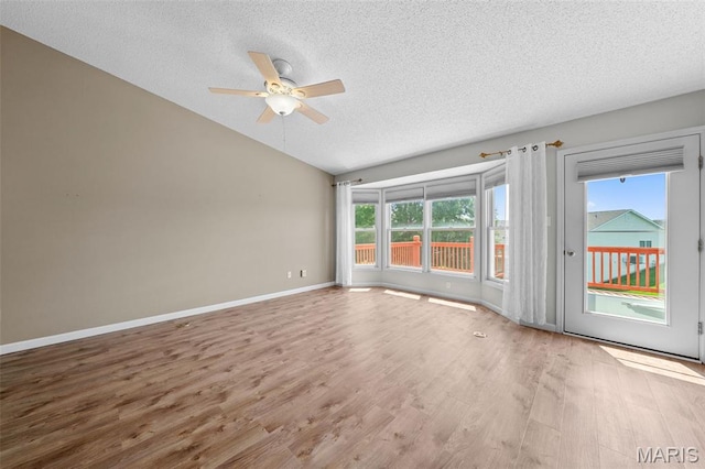 1149 Silo Bnd Unit 341A, Wentzville, MO 63385 - empty room with a textured ceiling, a ceiling fan, vaulted ceiling, and wood finished floors