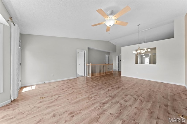 1149 Silo Bnd Unit 341A, Wentzville, MO 63385 - unfurnished living room with vaulted ceiling, wood finished floors, a ceiling fan, a chandelier, and a textured ceiling