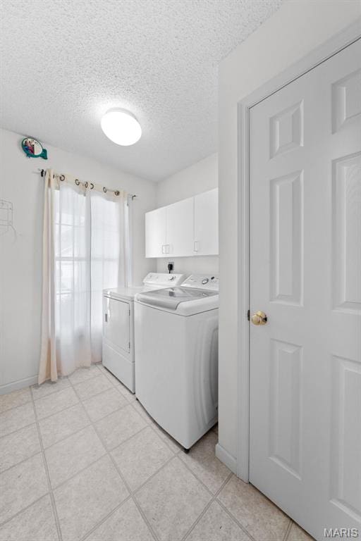 1149 Silo Bnd Unit 341A, Wentzville, MO 63385 - laundry area with washer and dryer, a textured ceiling, cabinet space, and light tile patterned floors