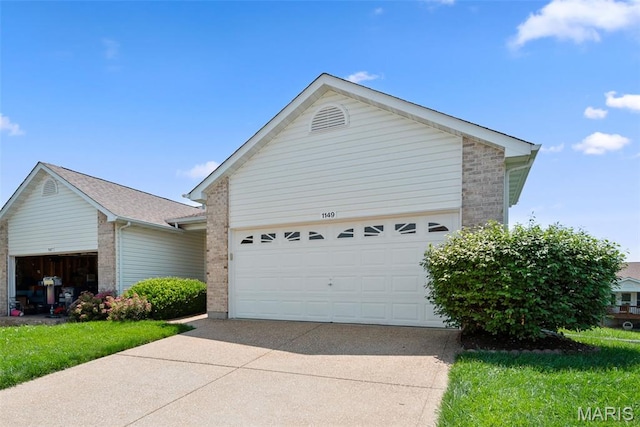 1149 Silo Bnd Unit 341A, Wentzville, MO 63385 - view of front of property with brick siding, concrete driveway, and a garage