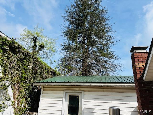 206 1st St, Steelville, MO 65565 - exterior view of metal roof and a chimney
