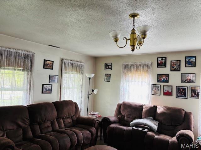 206 1st St, Steelville, MO 65565 - living room featuring a chandelier and a textured ceiling