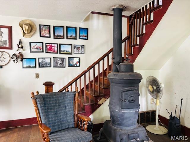 206 1st St, Steelville, MO 65565 - stairway featuring wood finished floors, baseboards, and a wood stove
