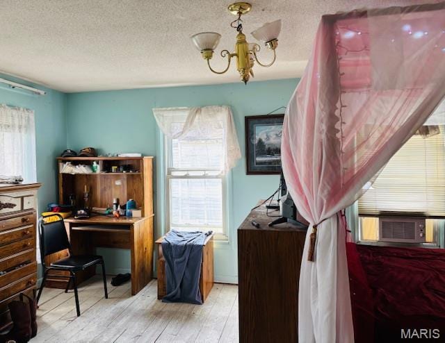 206 1st St, Steelville, MO 65565 - office area featuring plenty of natural light, a chandelier, light wood-style flooring, and a textured ceiling