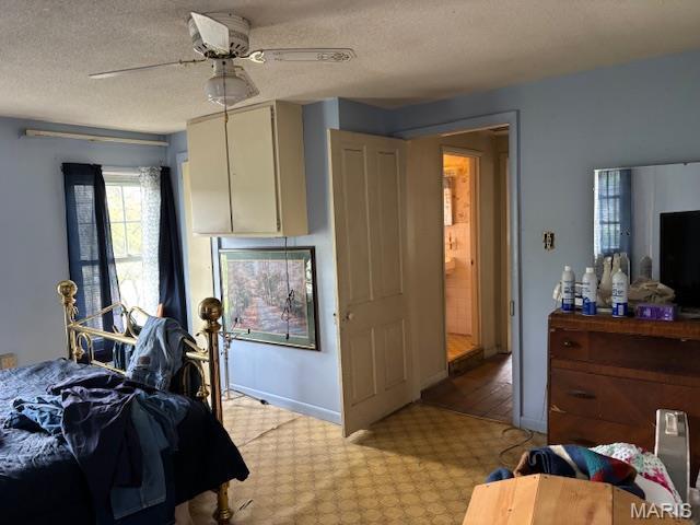 206 1st St, Steelville, MO 65565 - bedroom with a textured ceiling, baseboards, and ceiling fan