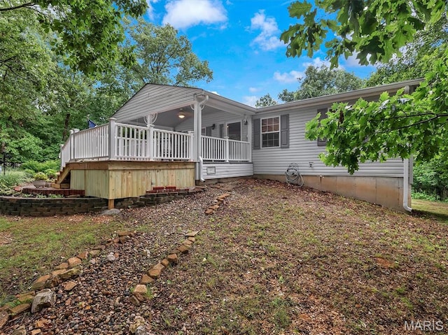 3870 Wilkinson Rd, De Soto, MO 63020 - back of house with stairs, a wooden deck, and a sunroom