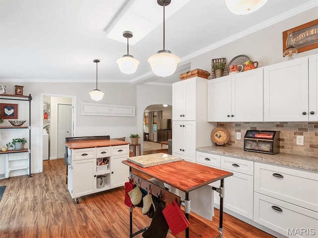 3870 Wilkinson Rd, De Soto, MO 63020 - kitchen with butcher block counters, arched walkways, ornamental molding, decorative backsplash, and white cabinetry