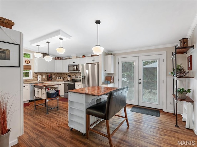 3870 Wilkinson Rd, De Soto, MO 63020 - kitchen featuring appliances with stainless steel finishes, ornamental molding, white cabinetry, plenty of natural light, and french doors