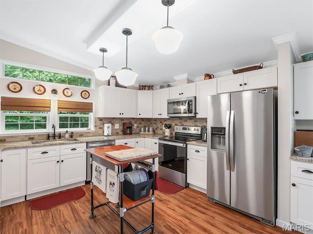 3870 Wilkinson Rd, De Soto, MO 63020 - kitchen with appliances with stainless steel finishes, white cabinets, backsplash, wood finished floors, and vaulted ceiling