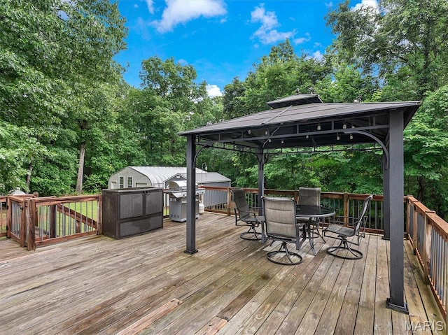 3870 Wilkinson Rd, De Soto, MO 63020 - wooden terrace featuring a gazebo, area for grilling, outdoor dining space, and view of scattered trees