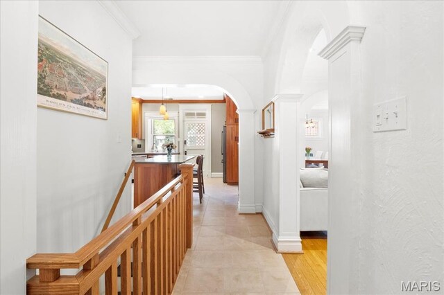 7440 Kingsbury Blvd, Saint Louis, MO 63130 - corridor featuring arched walkways, ornamental molding, light tile patterned flooring, ornate columns, and baseboards