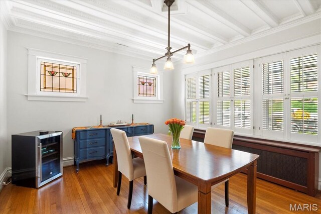 7440 Kingsbury Blvd, Saint Louis, MO 63130 - dining space featuring beam ceiling, healthy amount of natural light, wood finished floors, and radiator heating unit