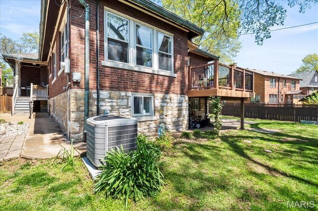 7440 Kingsbury Blvd, Saint Louis, MO 63130 - rear view of house with cooling unit, brick siding, a deck, and stone siding