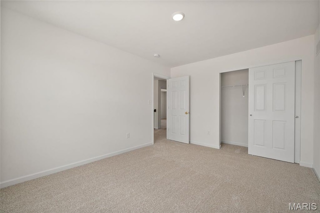 unfurnished bedroom with light colored carpet, baseboards, a closet, and recessed lighting
