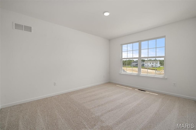 unfurnished room with baseboards and carpet flooring