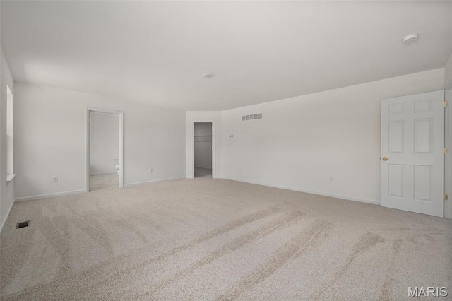 carpeted spare room with baseboards and a smoke detector