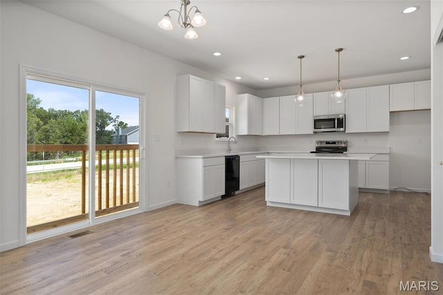 kitchen with stainless steel appliances, light countertops, baseboards, light wood-style flooring, and recessed lighting