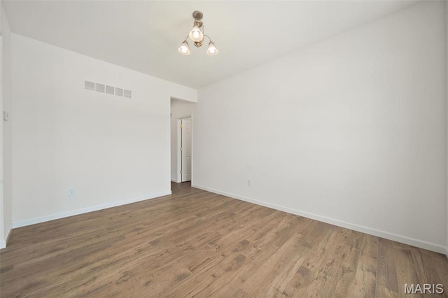 unfurnished room with wood finished floors and baseboards