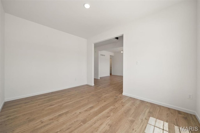unfurnished room with baseboards, light wood-style floors, and recessed lighting