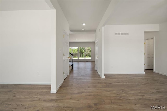 hall featuring baseboards, wood finished floors, and recessed lighting