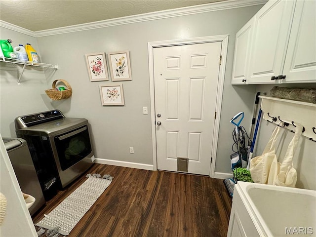 clothes washing area featuring cabinet space, dark wood-style floors, crown molding, baseboards, and independent washer and dryer
