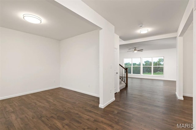 1170 Bloomfield Dr, Eureka, MO 63025 - unfurnished room featuring baseboards, dark wood-style flooring, stairway, and a ceiling fan