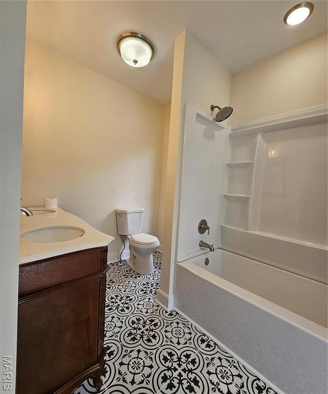 bathroom with toilet, vanity, shower / bath combination, baseboards, and tile patterned flooring