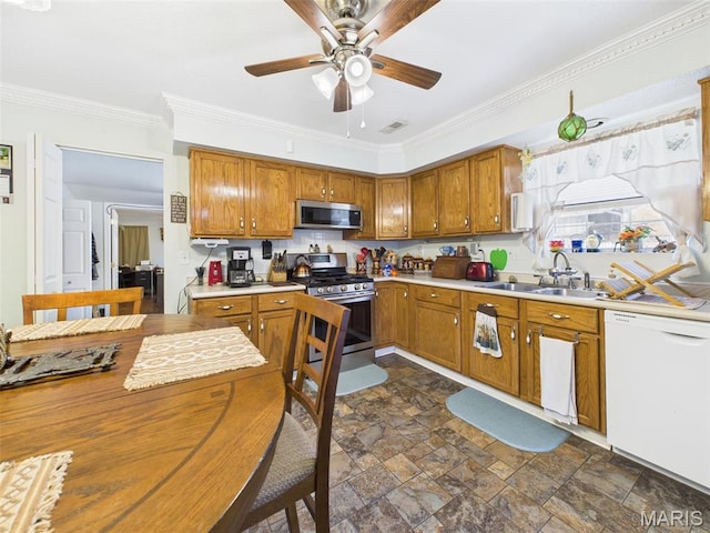 462 Harrison St, Lebanon, MO 65536 - kitchen with appliances with stainless steel finishes, a sink, light countertops, crown molding, and brown cabinets
