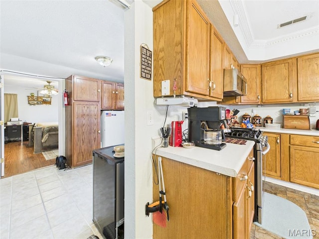 462 Harrison St, Lebanon, MO 65536 - kitchen featuring appliances with stainless steel finishes, light countertops, and brown cabinetry