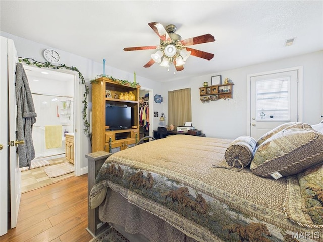 462 Harrison St, Lebanon, MO 65536 - bedroom featuring wood finished floors, ceiling fan, ensuite bathroom, and a spacious closet