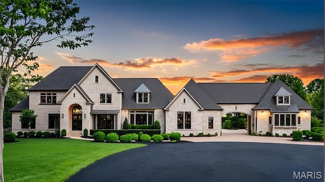 42 Rolling Rock Ct, Saint Louis, MO 63124 - french country style house featuring stone siding, a yard, and curved driveway