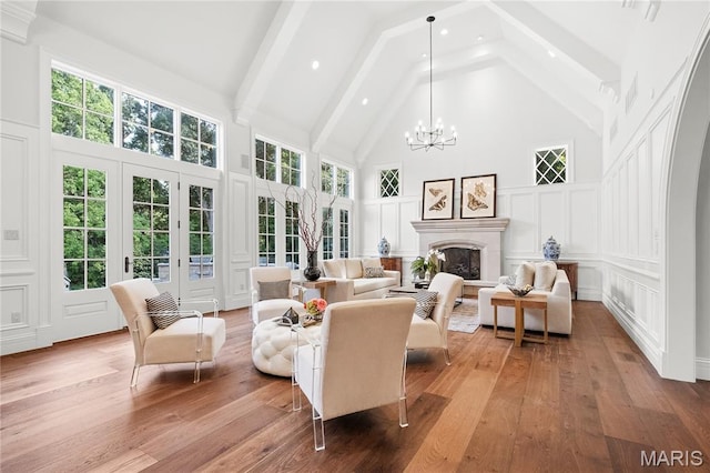 42 Rolling Rock Ct, Saint Louis, MO 63124 - living area featuring a decorative wall, high vaulted ceiling, a chandelier, healthy amount of natural light, and hardwood / wood-style floors