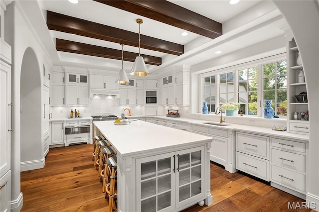 42 Rolling Rock Ct, Saint Louis, MO 63124 - kitchen with a sink, a warming drawer, beam ceiling, decorative backsplash, and a center island