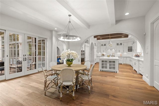 42 Rolling Rock Ct, Saint Louis, MO 63124 - dining area with arched walkways, beam ceiling, light wood-type flooring, recessed lighting, and a chandelier
