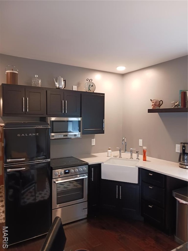 205 Lake Dr, Gray Summit, MO 63039 - kitchen with appliances with stainless steel finishes, a sink, dark wood-style floors, and light countertops