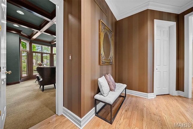 hallway featuring ornamental molding, baseboards, beam ceiling, coffered ceiling, and wood finished floors