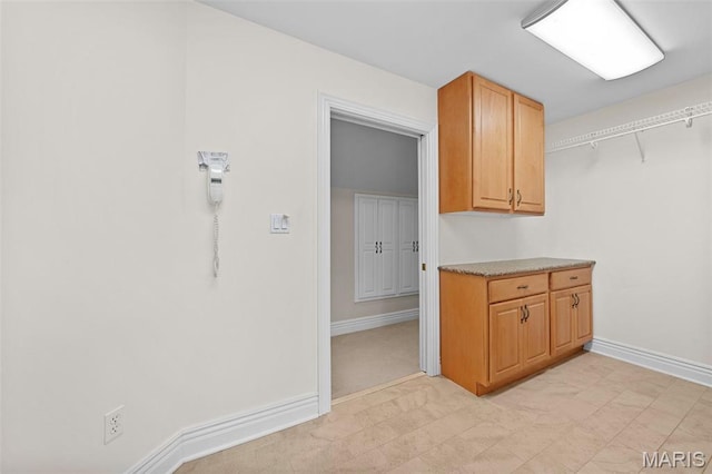 kitchen with baseboards and light countertops