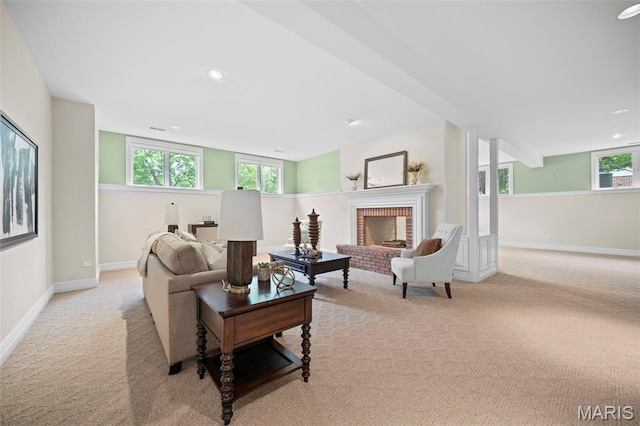 living area featuring light colored carpet, baseboards, a fireplace, and recessed lighting