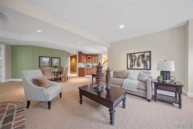 living area with light colored carpet, recessed lighting, baseboards, and stairs