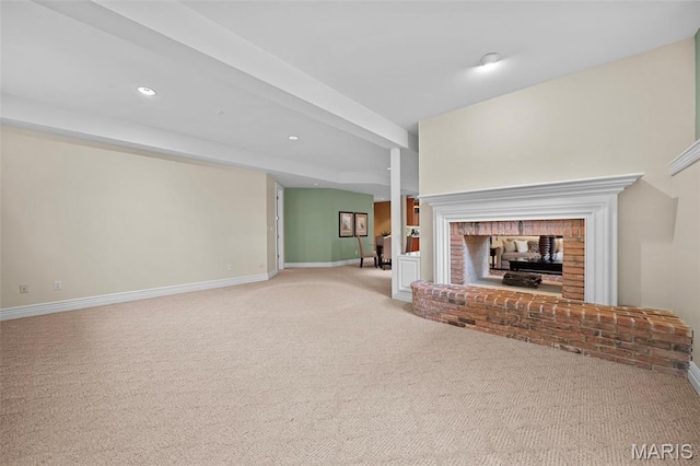 unfurnished living room with a fireplace, light carpet, baseboards, and recessed lighting