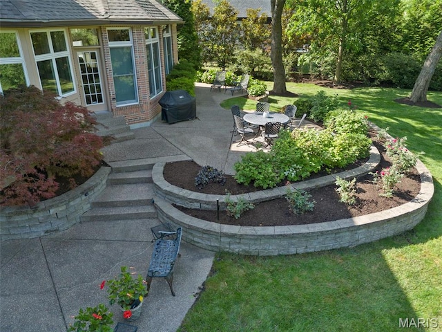 view of grassy yard featuring a patio and entry steps
