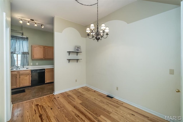 1003 Allen Ave, Saint Louis, MO 63104 - unfurnished dining area with light wood finished floors, a sink, a chandelier, baseboards, and vaulted ceiling