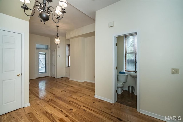 1003 Allen Ave, Saint Louis, MO 63104 - entryway featuring light wood-style floors, a chandelier, and baseboards